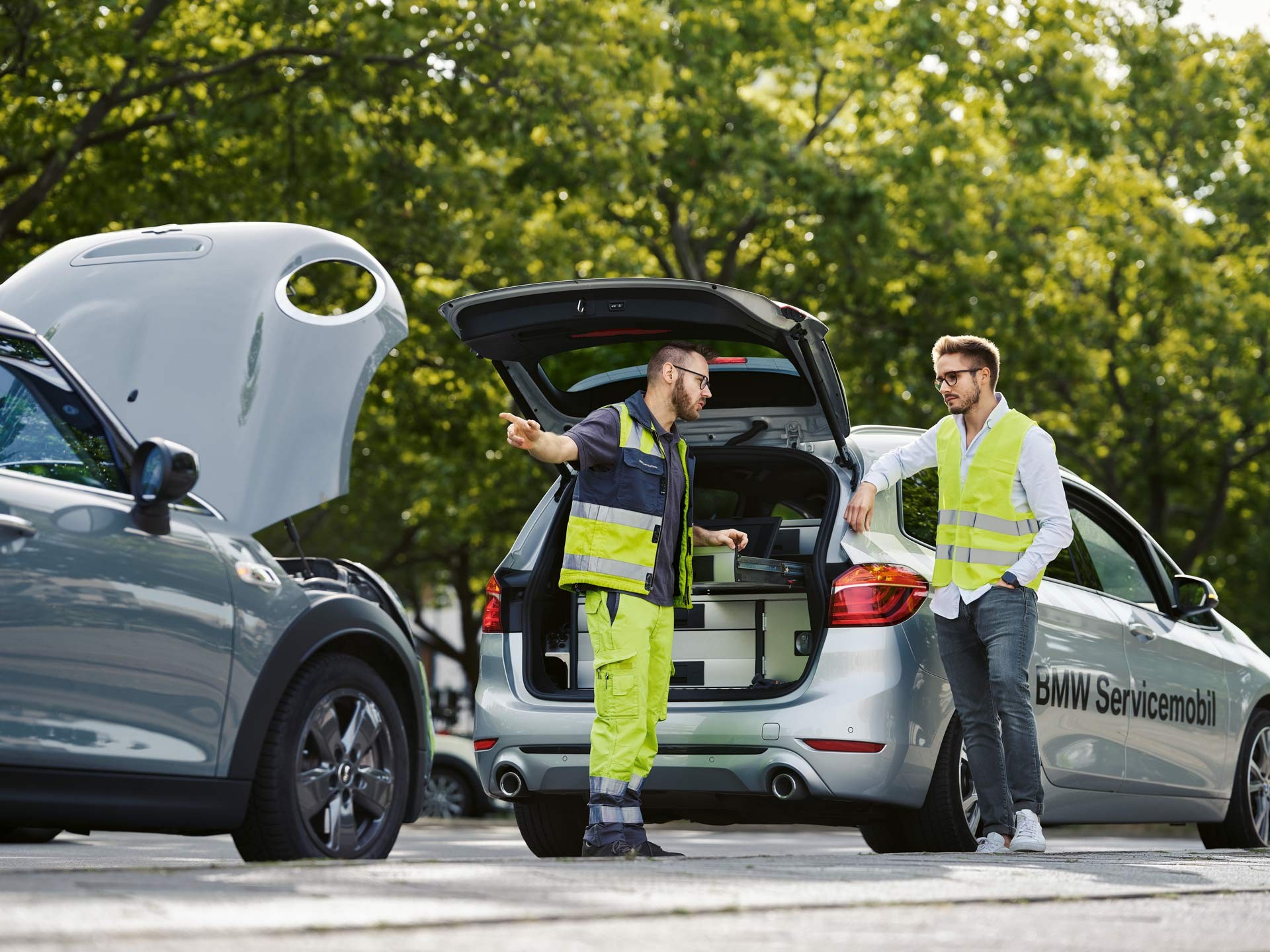 Roadside assistance team working from an open service vehicle on a city street